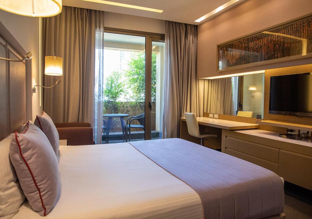 Postel nebo postele na pokoji v ubytování Saifi Suites Hotel