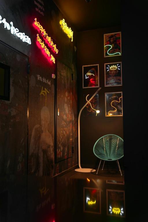 a room with a chair and signs on the wall at SO City Hotel Adults Only in St. Julianʼs