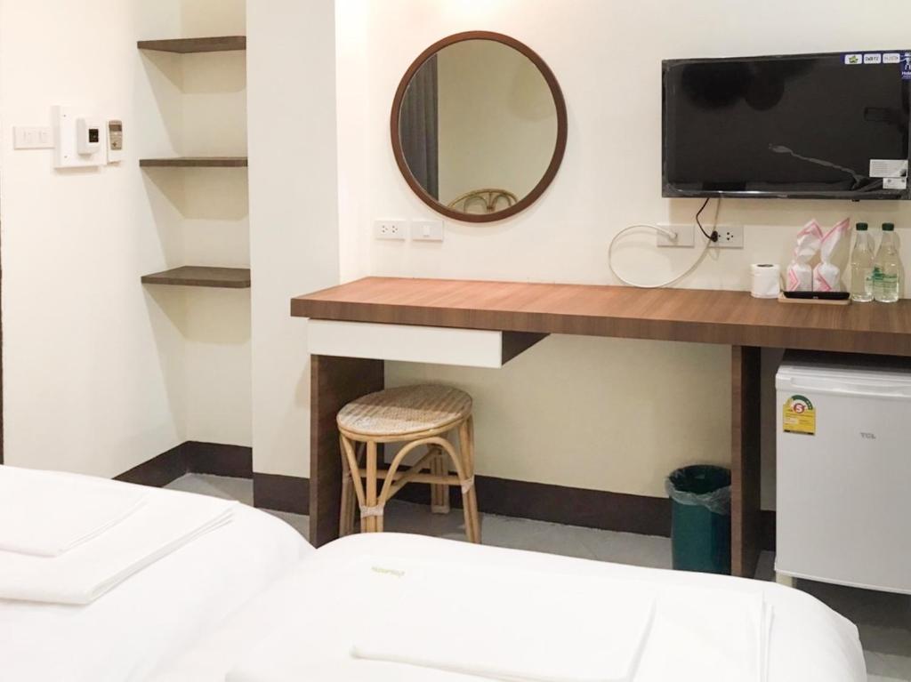 Postel nebo postele na pokoji v ubytování บ้านสวนอินทาวน์ Baansuan in Town Hotel