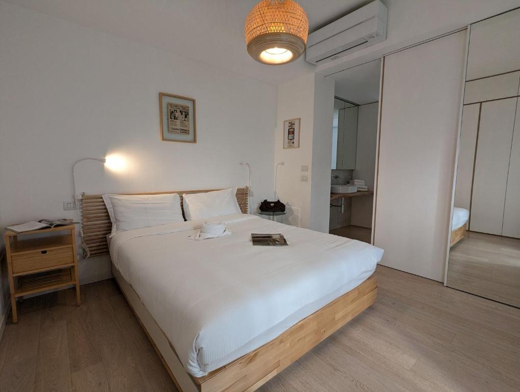 Un pat sau paturi într-o cameră la Papavero70