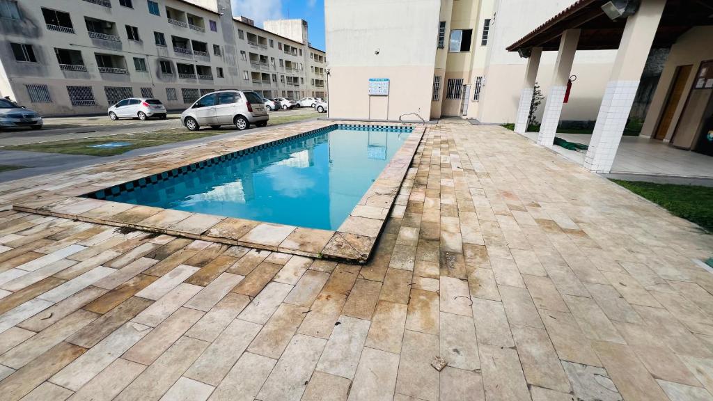 a swimming pool on the side of a building at Apartamento Home Practice Flat in São Luís