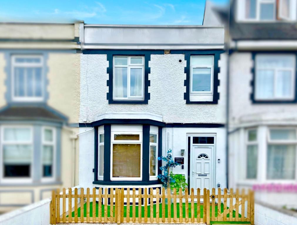 a toy house with a wooden fence in front of it at Castle View in Stafford