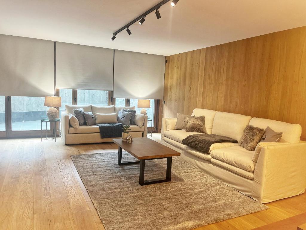 a living room with a couch and a table at ISARD MOUNTAIN RESIDENCE in El Tarter