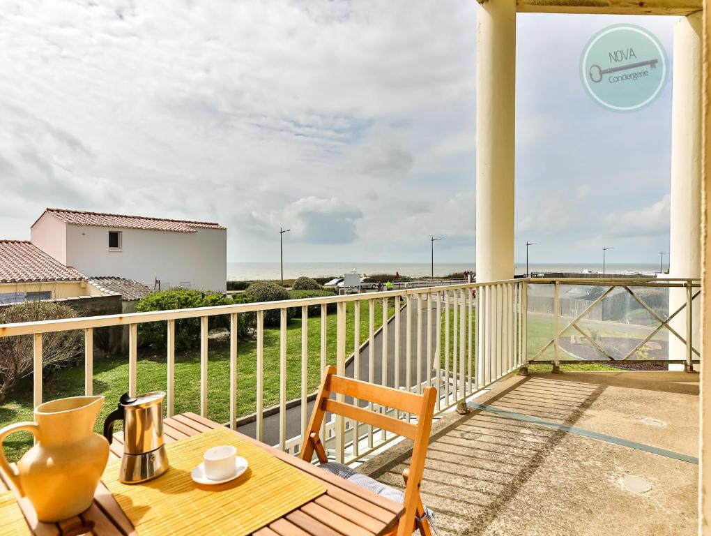 un balcon avec une table et des chaises et une vue sur l'océan dans l'établissement Vif océan, à Saint-Hilaire-de-Riez