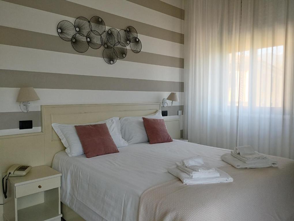 Postel nebo postele na pokoji v ubytování Hotel La Fontana