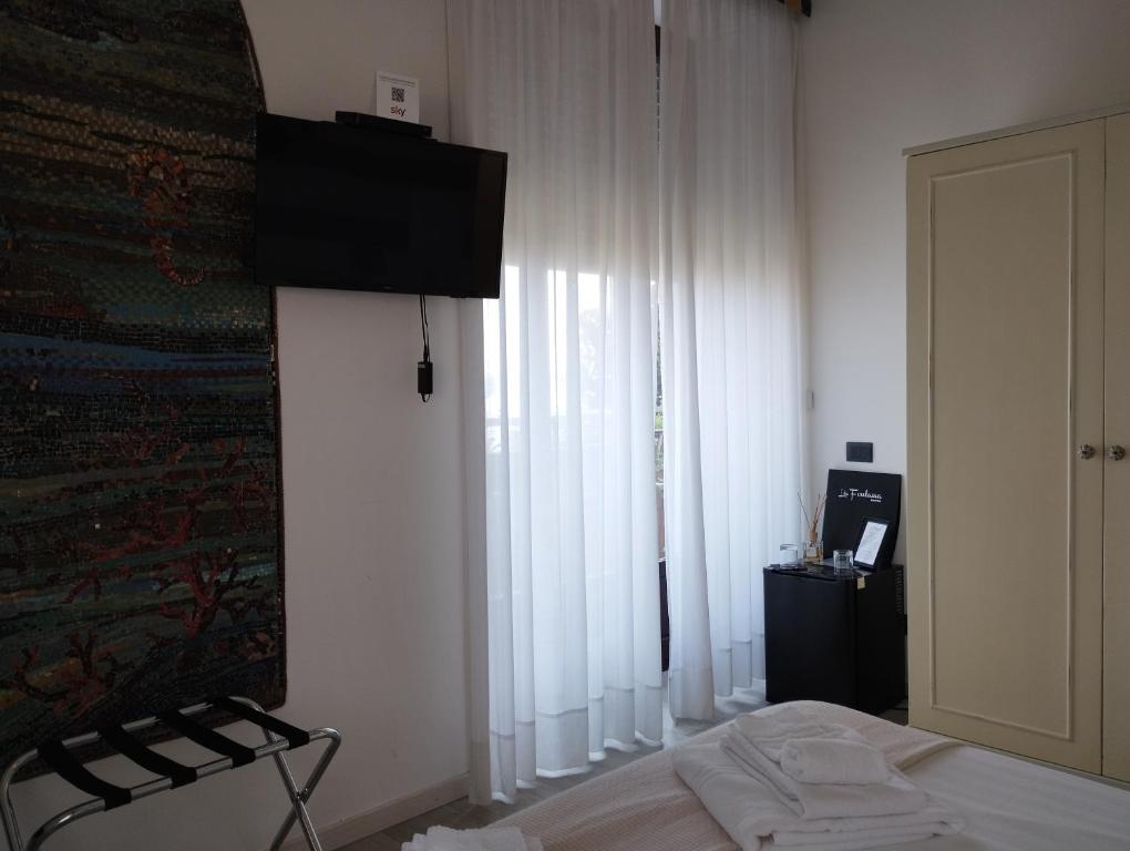 Postel nebo postele na pokoji v ubytování Hotel La Fontana
