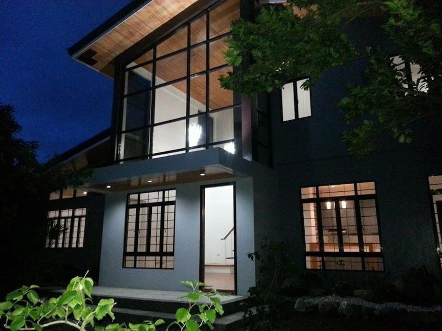 a black house with large windows at night at Casa Erlinda, modern newly built house 3BR for 8! in Tigaon