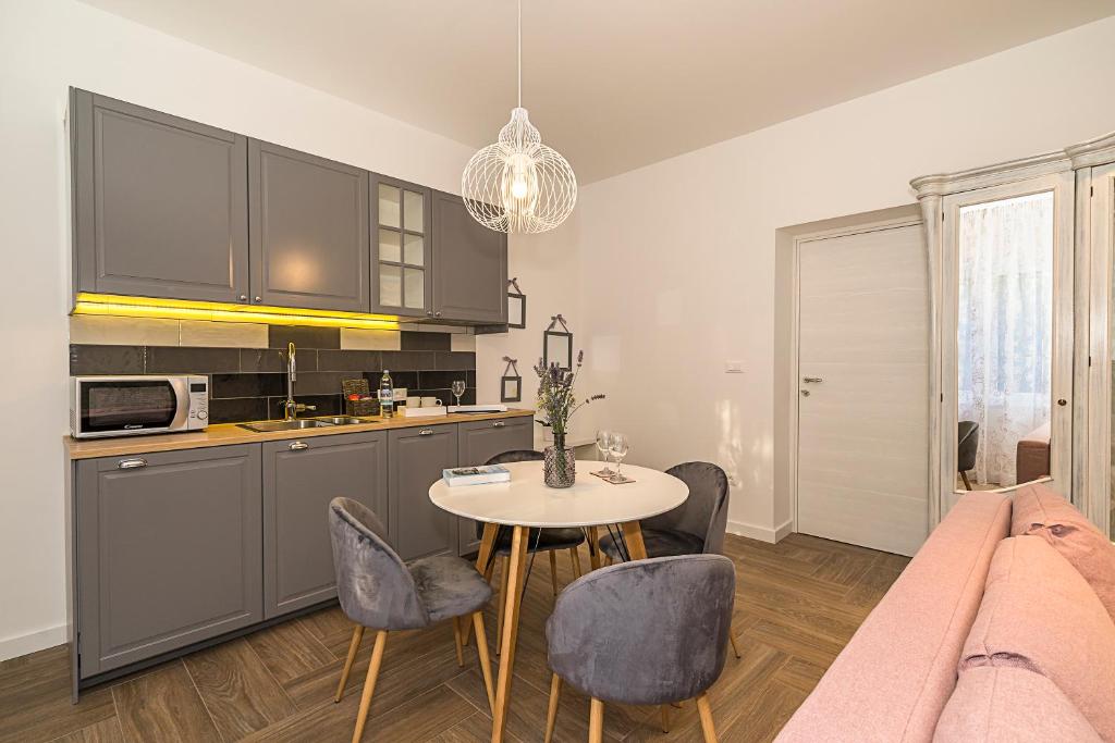 a kitchen and dining room with a table and chairs at Studio apartments Marcel in Split