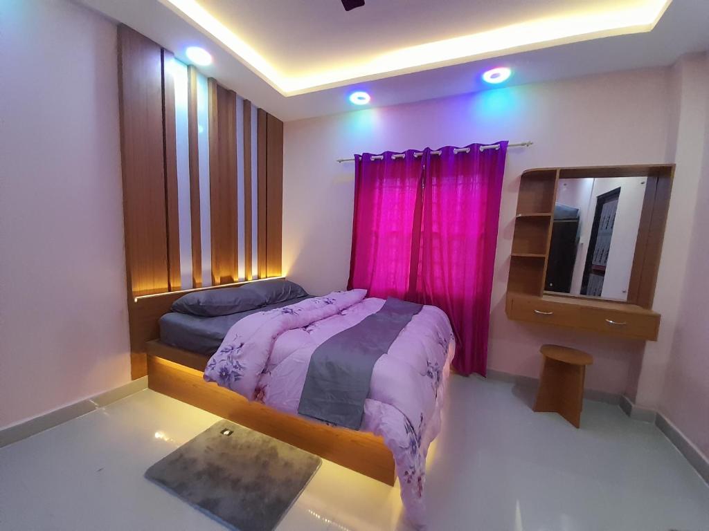 um quarto com uma cama e um espelho e cor-de-rosa cortinas em York Air B & B em Kathmandu