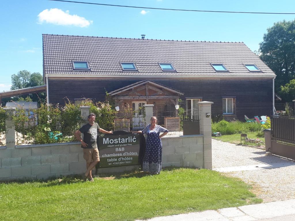 two people standing next to a sign in front of a house at 5 bedroom-5 bathroom Gîte with free wifi and parking chez Mostarlić B&B in Bouconville