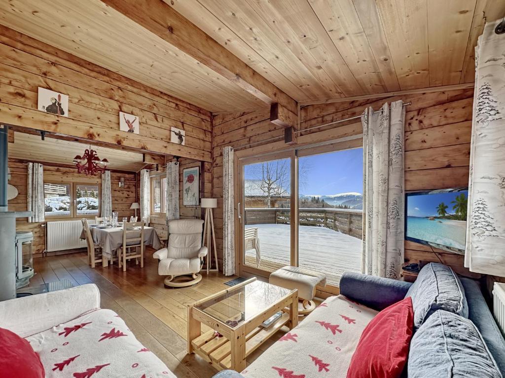a living room with a couch and a table at CH201 Chalet 6 Pers in Les Carroz d'Araches