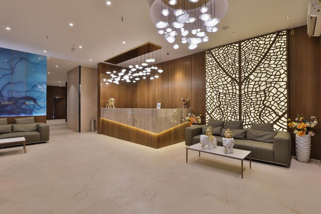 a lobby of a hotel with couches and a table at Hotel Elements Surat in Surat