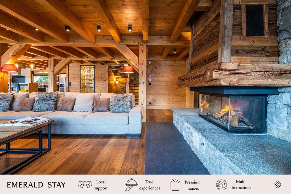 a living room with a couch and a fireplace at Abachi Chalet Les Gets - by EMERALD STAY in Les Gets