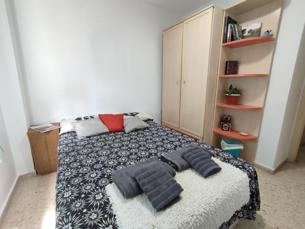 a bedroom with a bed with towels on it at Habitación Privada Juan in Estepona
