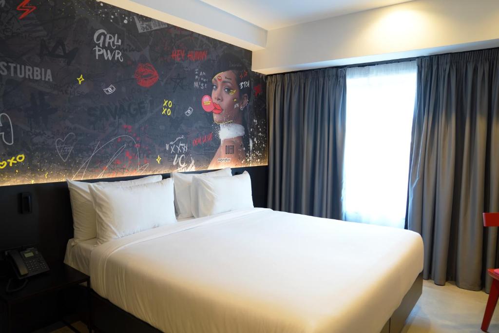 a hotel room with a bed and a painting on the wall at SO City Hotel Adults Only in St. Julianʼs