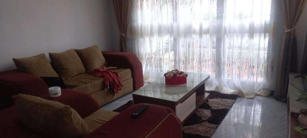 a living room with a couch and a coffee table at Emebet Tesfaye's House, in Addis Ababa