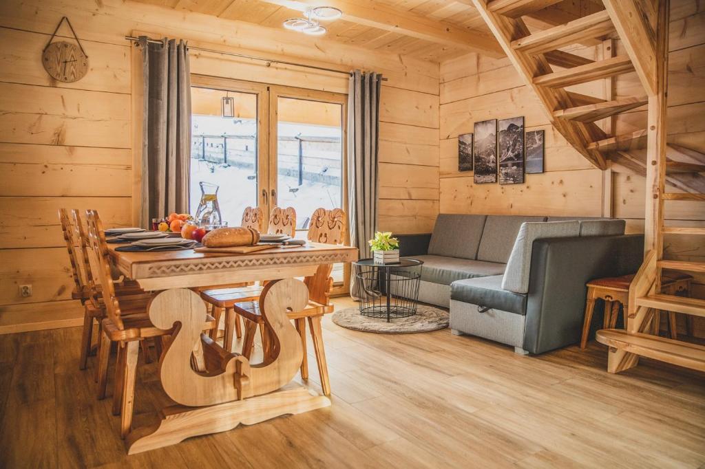 a living room with a table and a couch at Domek u Cianka w Kościelisku in Kościelisko