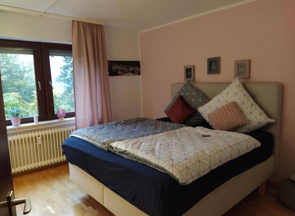 a bedroom with a bed and a window at Schöne Ferienwohnung mitten in Koblenz in Koblenz