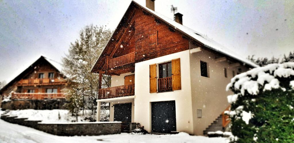 een huis is bedekt met sneeuw met bij Chalet Stella 5* à 2mn des pistes in Saint-Chaffrey