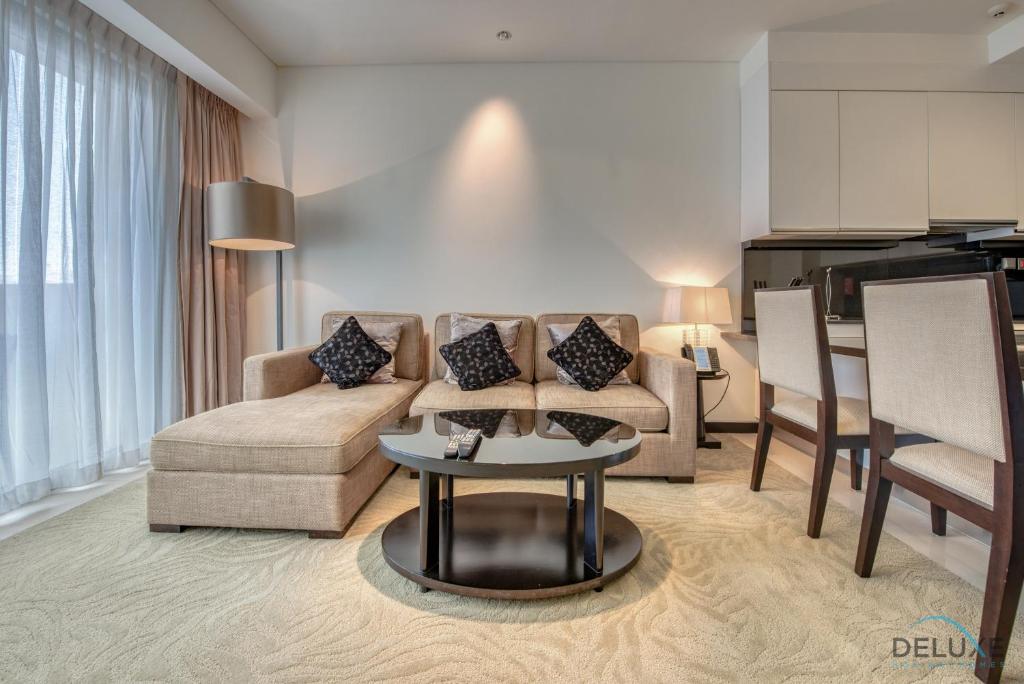 a living room with a couch and a table at Posh 1BR at The Address Residences Dubai Marina by Deluxe Holiday Homes in Dubai