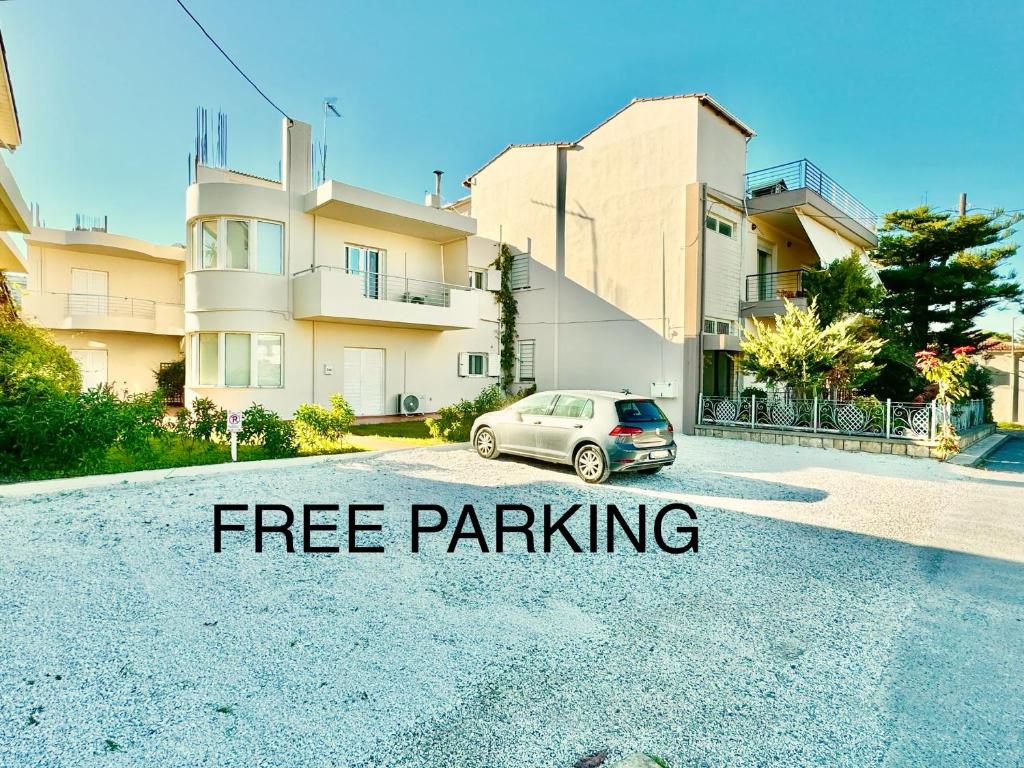 a car parked in a parking lot in front of a building at Giorgos Large Size Apartments -Family Friendly with Free Parking and Yard Views in Heraklio