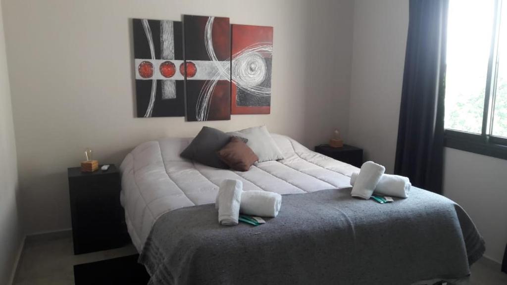a bedroom with a large white bed with two pillows at Complejo Ermindo I in Rafaela