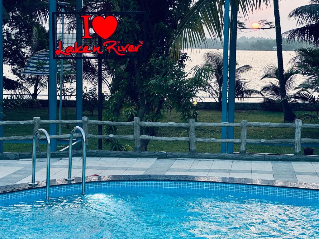 a swimming pool with a sign that says i heart lake trust at Lake N River Resort Munroe Island in Munroe Island