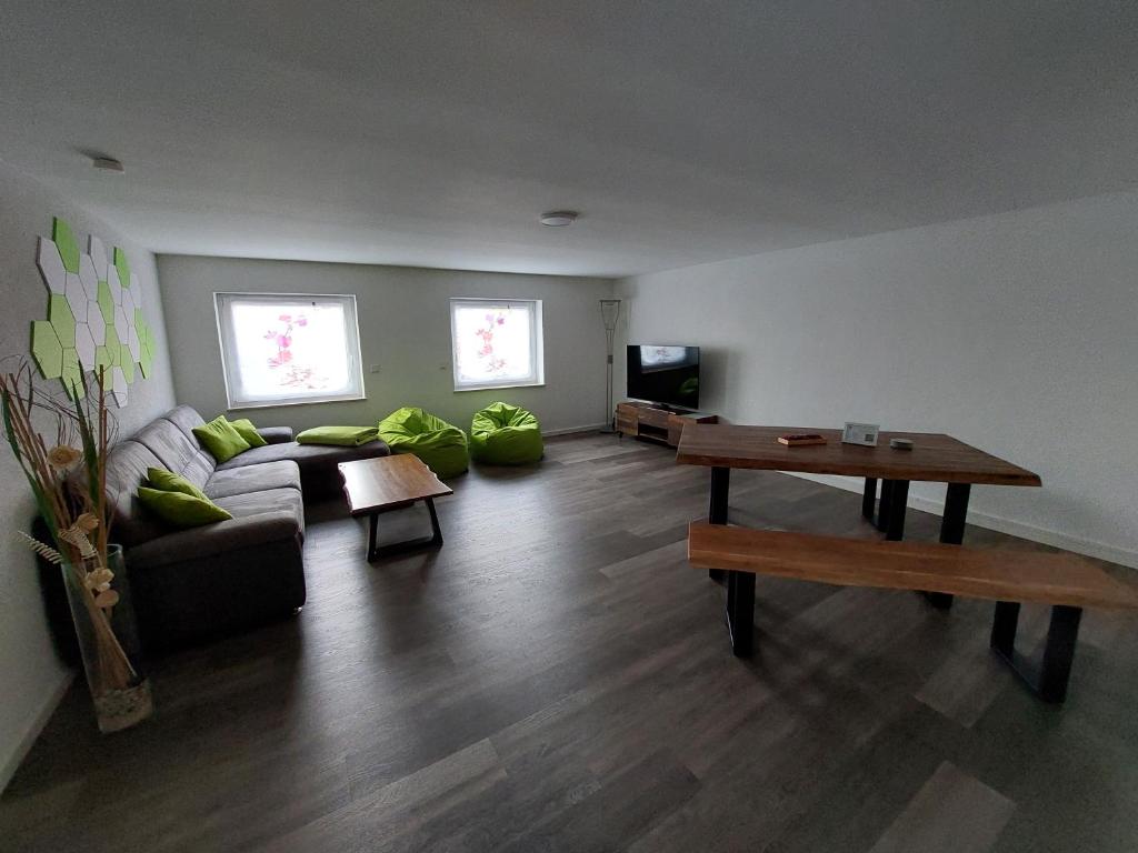 a living room with a couch and a table at Titel Am Fuße der Rhön, ist es schön in Bad Kissingen