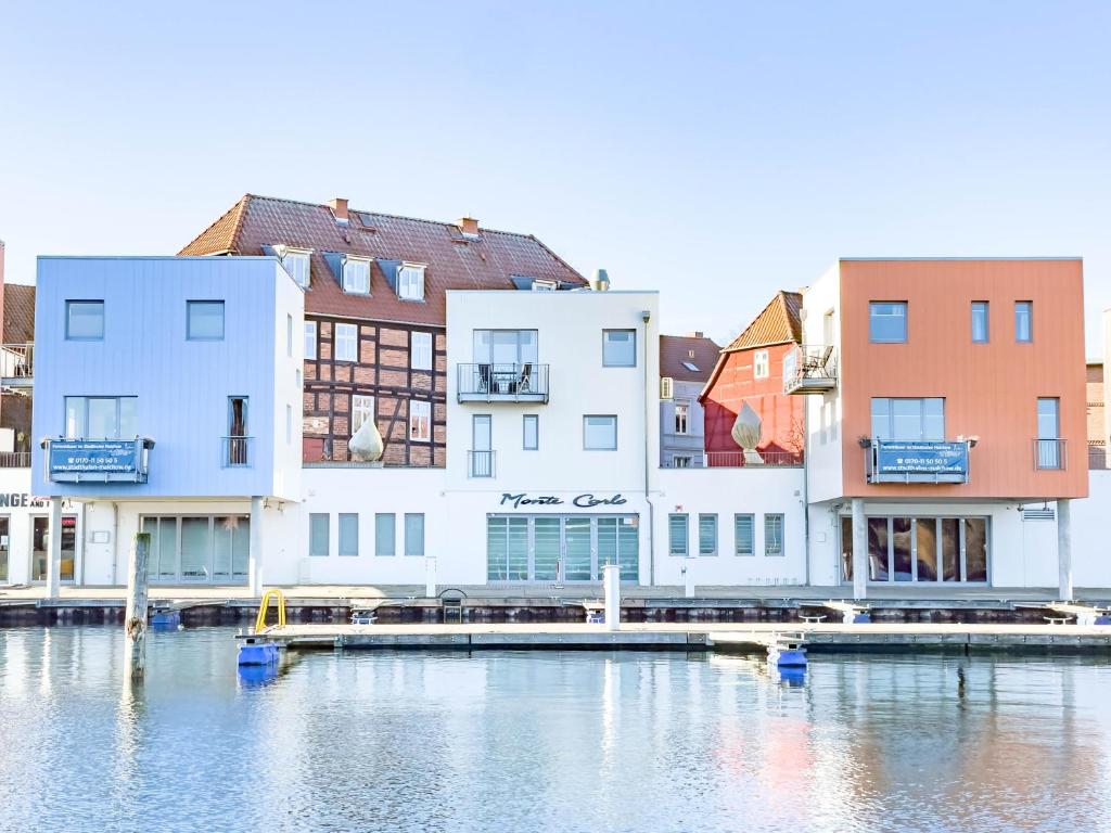 a group of buildings next to a body of water at Hafenresidenz in Malchow