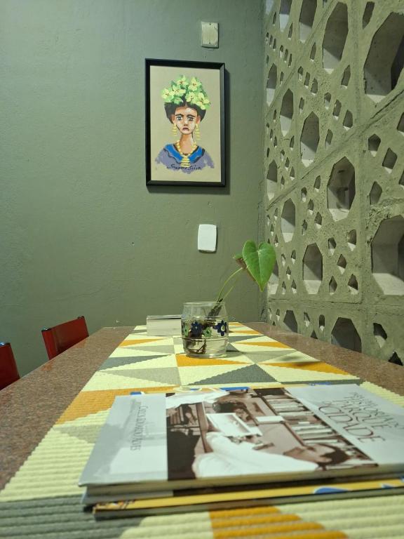 a table with a picture of a woman on it at Casa Frida 1 in Natal