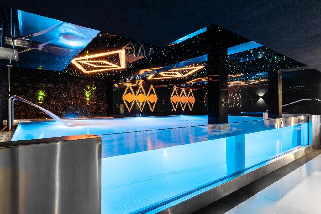 a nightclub with blue lighting and a dance floor at Aparthotel Diamond SPA Aqua in Białka Tatrzańska
