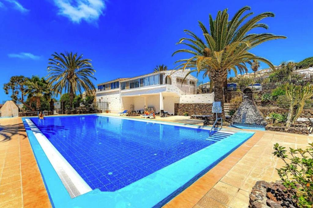 a swimming pool in front of a villa at Tropicalidays Oceanview Chayofa in Chayofa