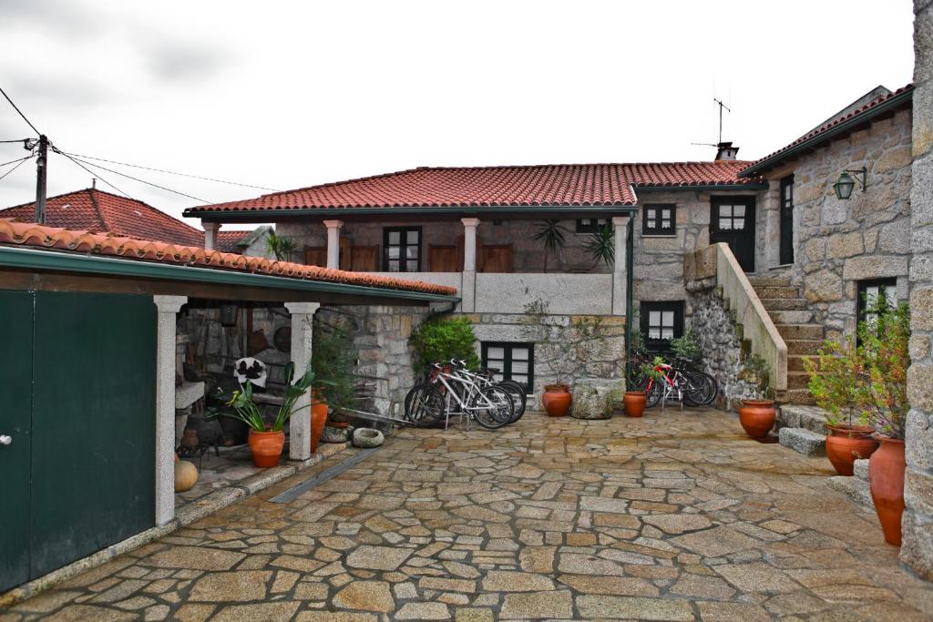 a courtyard of a house with bikes parked in it at Casas do Cavaleiro Eira in Soajo