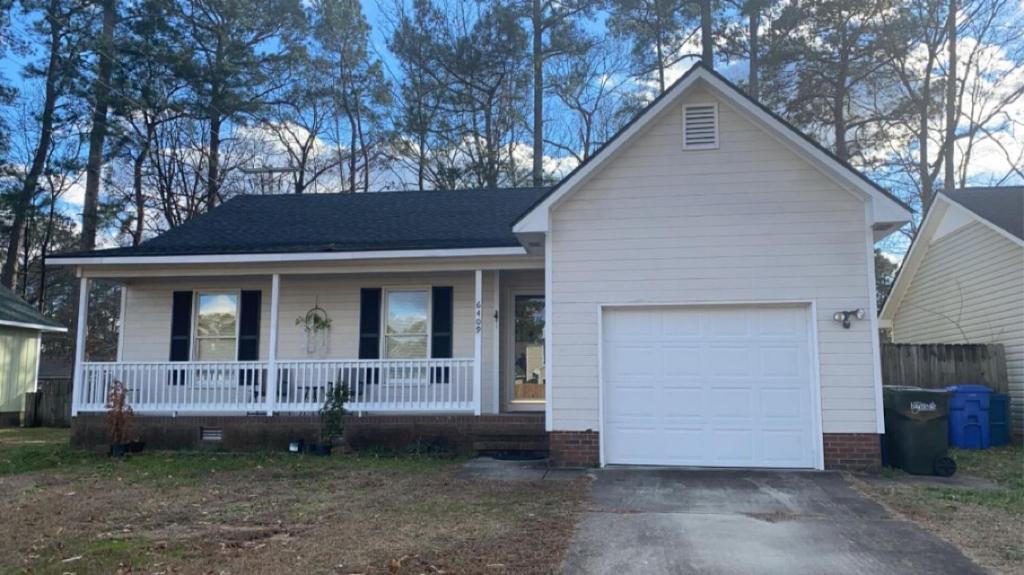 a small white house with a white garage at B1 Guest House in Hope Mills