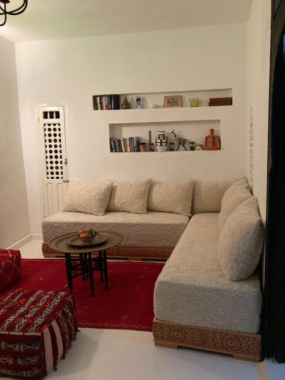 a living room with a couch and a table at Dar Said in Asilah