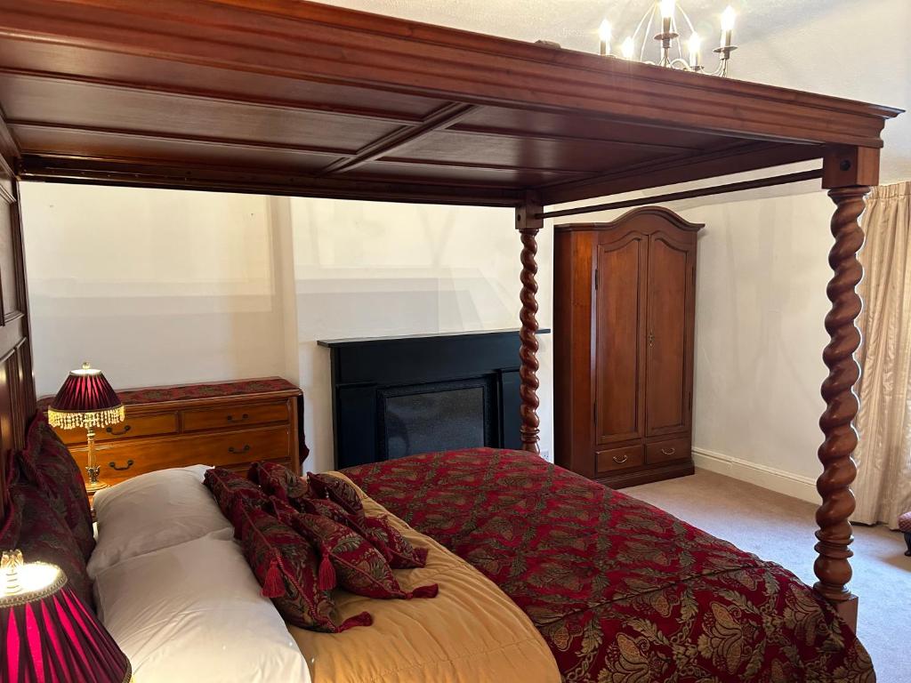 a bed with a wooden canopy in a bedroom at Abba House in Llandudno