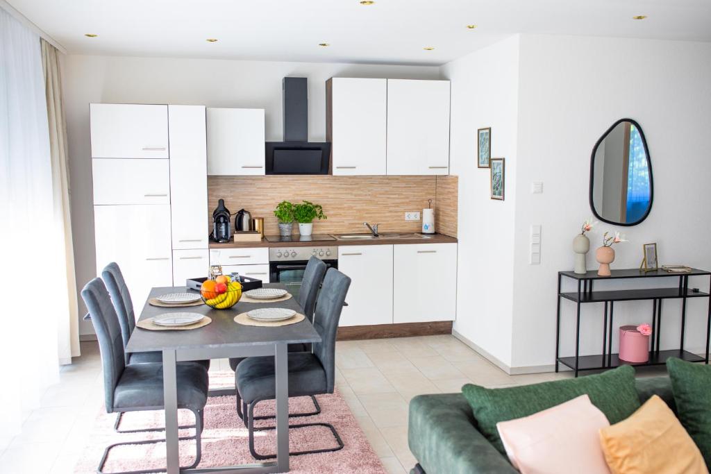 a kitchen and living room with a table and chairs at Auszeit in Radolfzell in Radolfzell am Bodensee