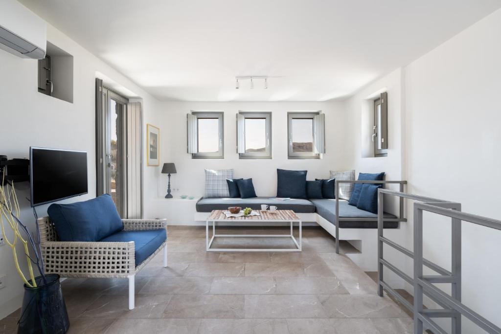 a living room with a couch and a table at Ammoa Beach Residences in Vayiá