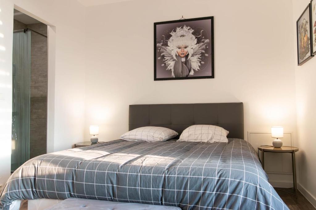 a bedroom with a bed with two lamps on the wall at la chambre de l'ange in Saint-Herblain