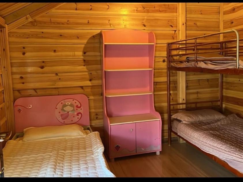 a room with a bunk bed and a bunk room with a bunk beduteneway at الكوخ الريفي in Al Majma'ah