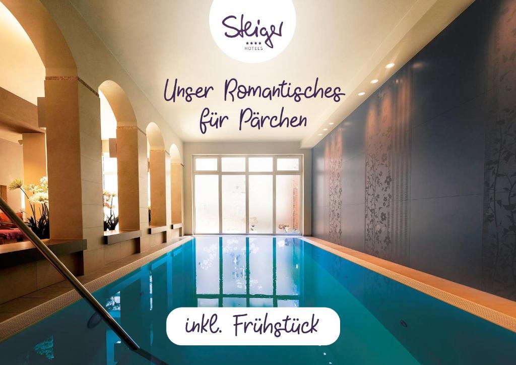 a swimming pool in a hotel with the words under renovations five perrier at STEIGER Hotel Sebnitzer Hof in Bad Schandau