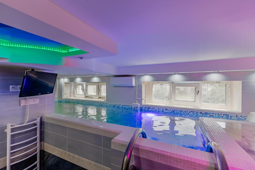 a swimming pool with a tv in a room at Luxury Apartment with Pool and Hammam in Kyiv