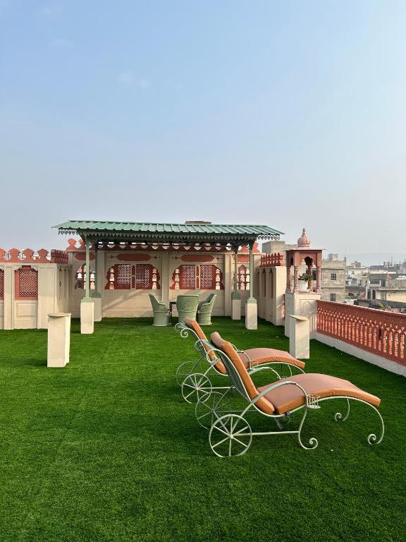 a carriage on the grass on a roof at Suryaa Villa - A Boutique Heritage Hotel in Jaipur