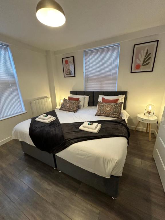 una camera da letto con un grande letto con due asciugamani di Spacious 3 bedroom apartment close to marina, 2 parking spaces, kingsize or single beds a Southampton