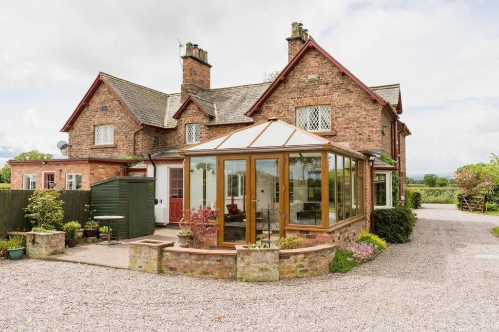 a house with a conservatory in front of it at Traditional English country 4 bed cottage near Chester - For 7 people in Pulford