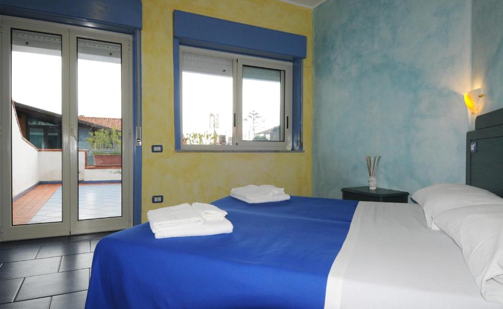 Ein Bett oder Betten in einem Zimmer der Unterkunft Oasi Azzurra -trilocale Plus 1