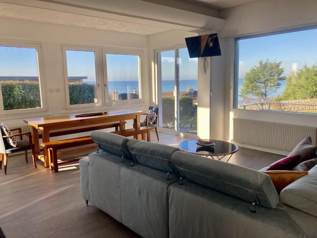 - un salon avec un canapé et un piano dans l'établissement Les Penates, à Veules-les-Roses