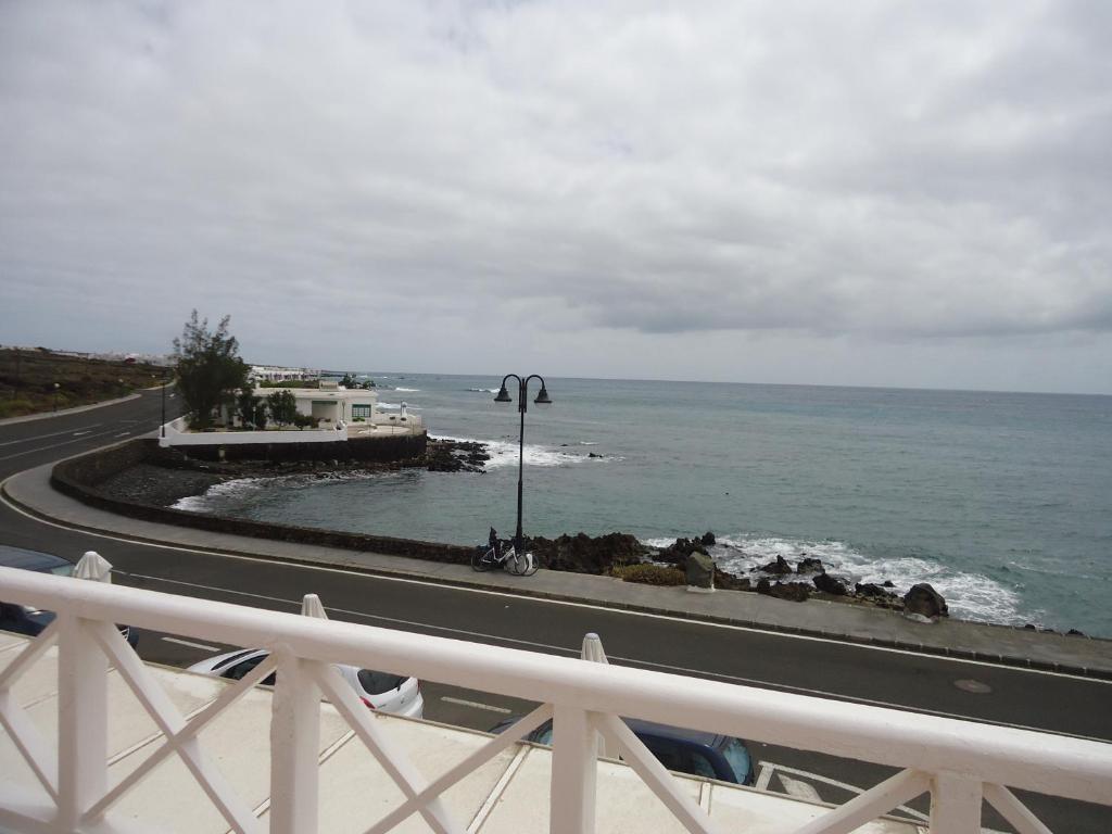 a view of the ocean from a balcony at Apartamentos El Lago in Arrieta