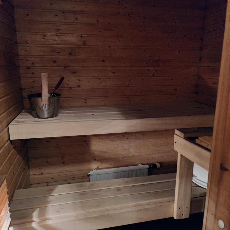 a sauna with wooden walls and a wooden shelf at Villa Niva in Rovaniemi
