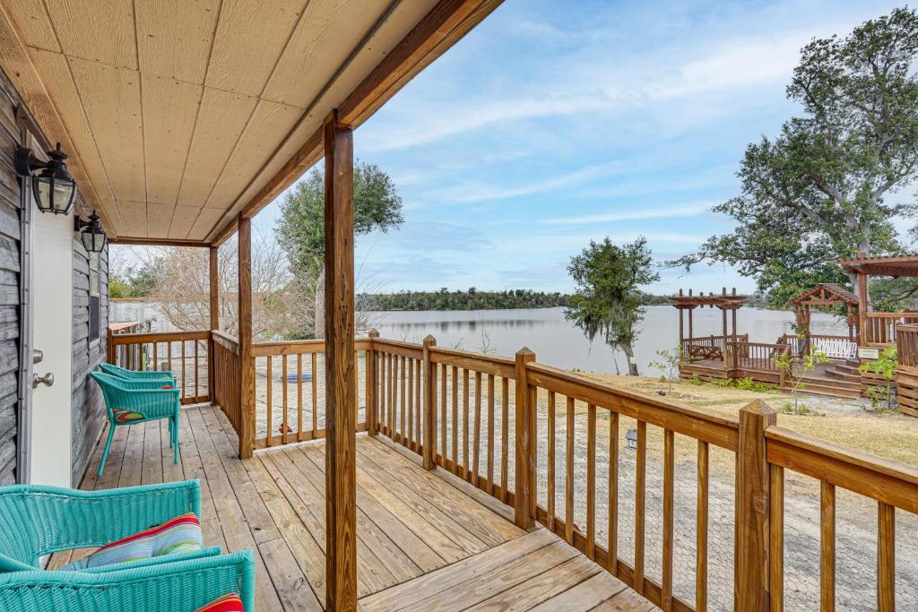 a porch with chairs and a view of the water at Lakefront Panama City Studio with Hot Tub Access in Panama City